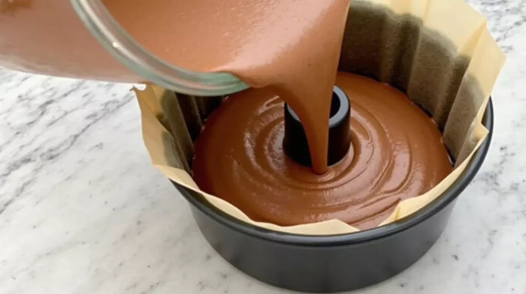 Chocolate pound cake batter poured into a loaf pan