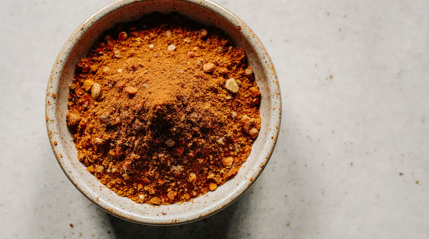 Homemade Thai spice mix in a small bowl with warm natural colors